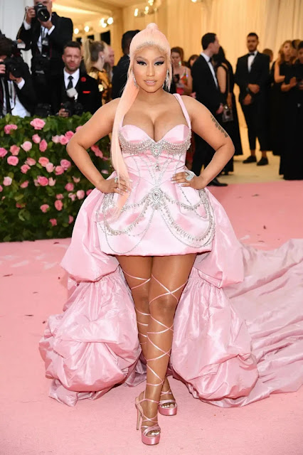 Nicki Minaj standing in a full-length photograph