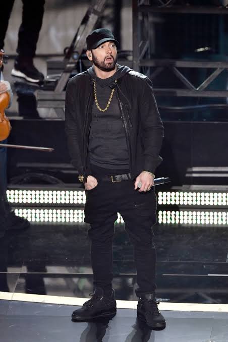 Eminem standing on stage during a live performance