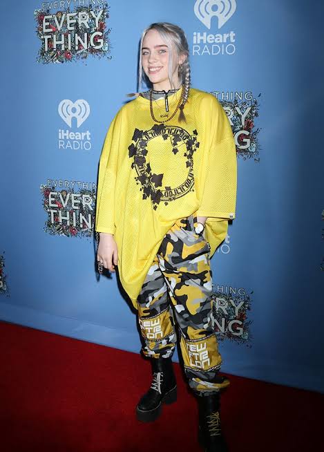Billie Eilish standing on a red carpet
